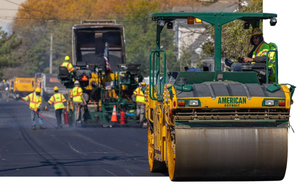 Steamroller and workers on road