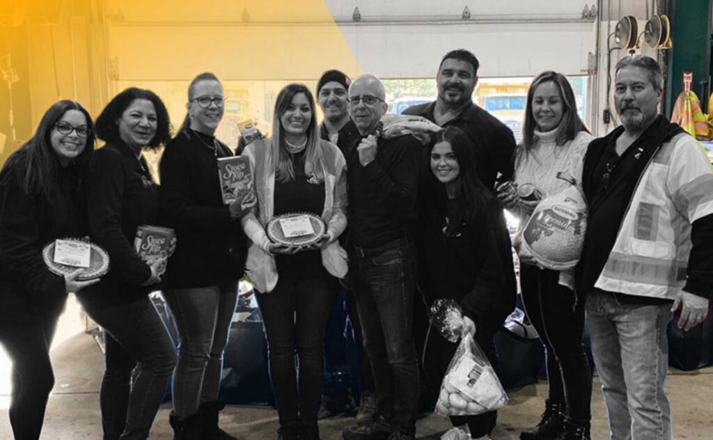 Earle American group picture with employees and donations