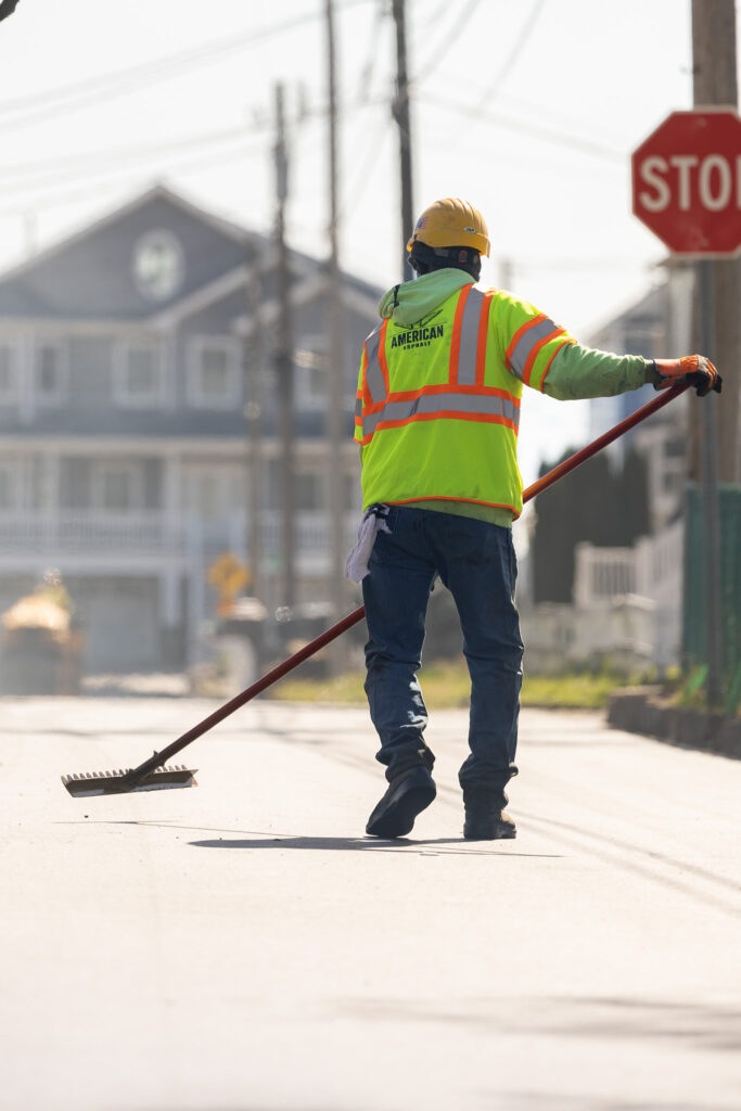 Earle American employee works on asphalt resurfacing job site