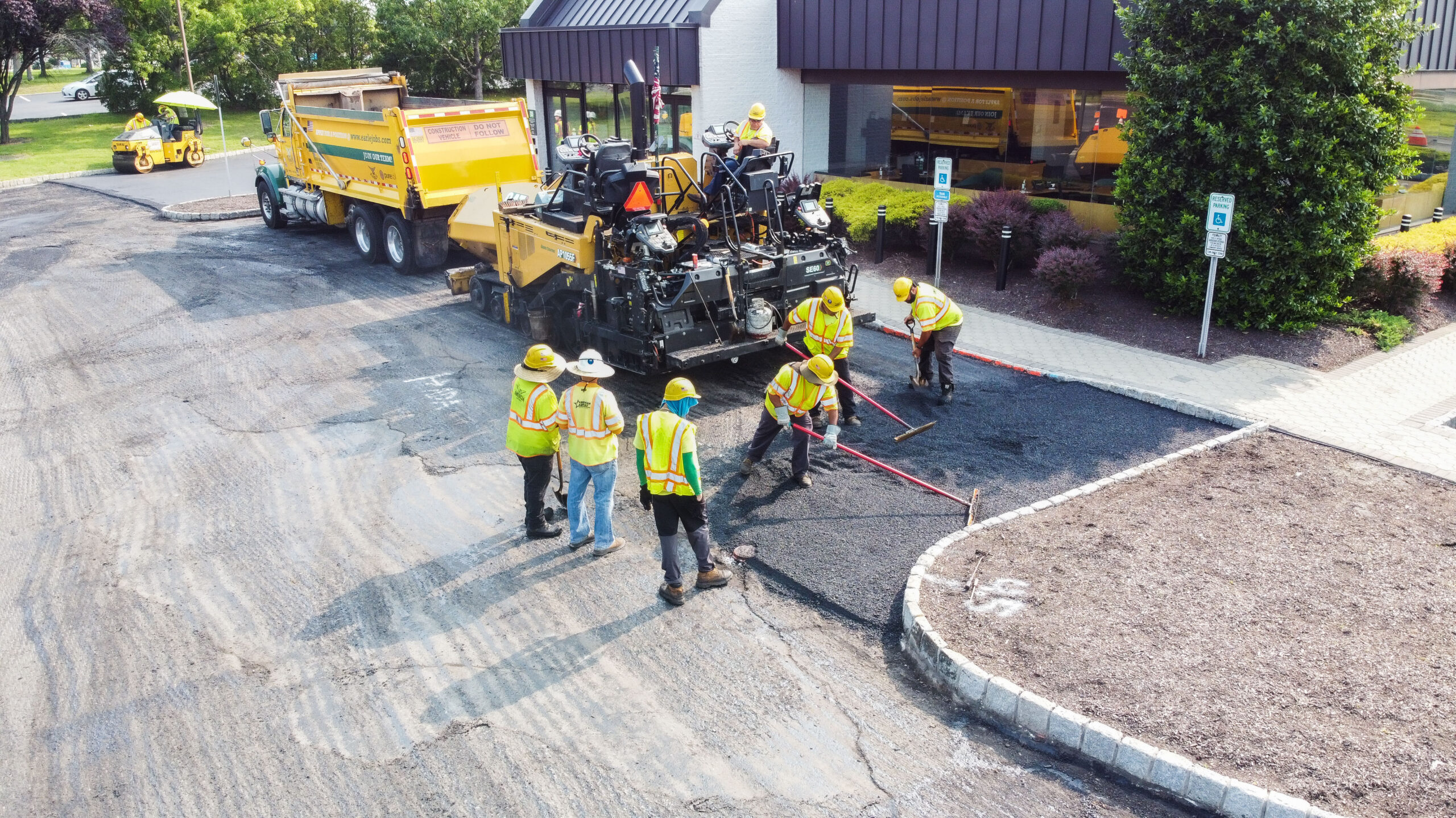Earle American contractors installing new asphalt in handicap spots