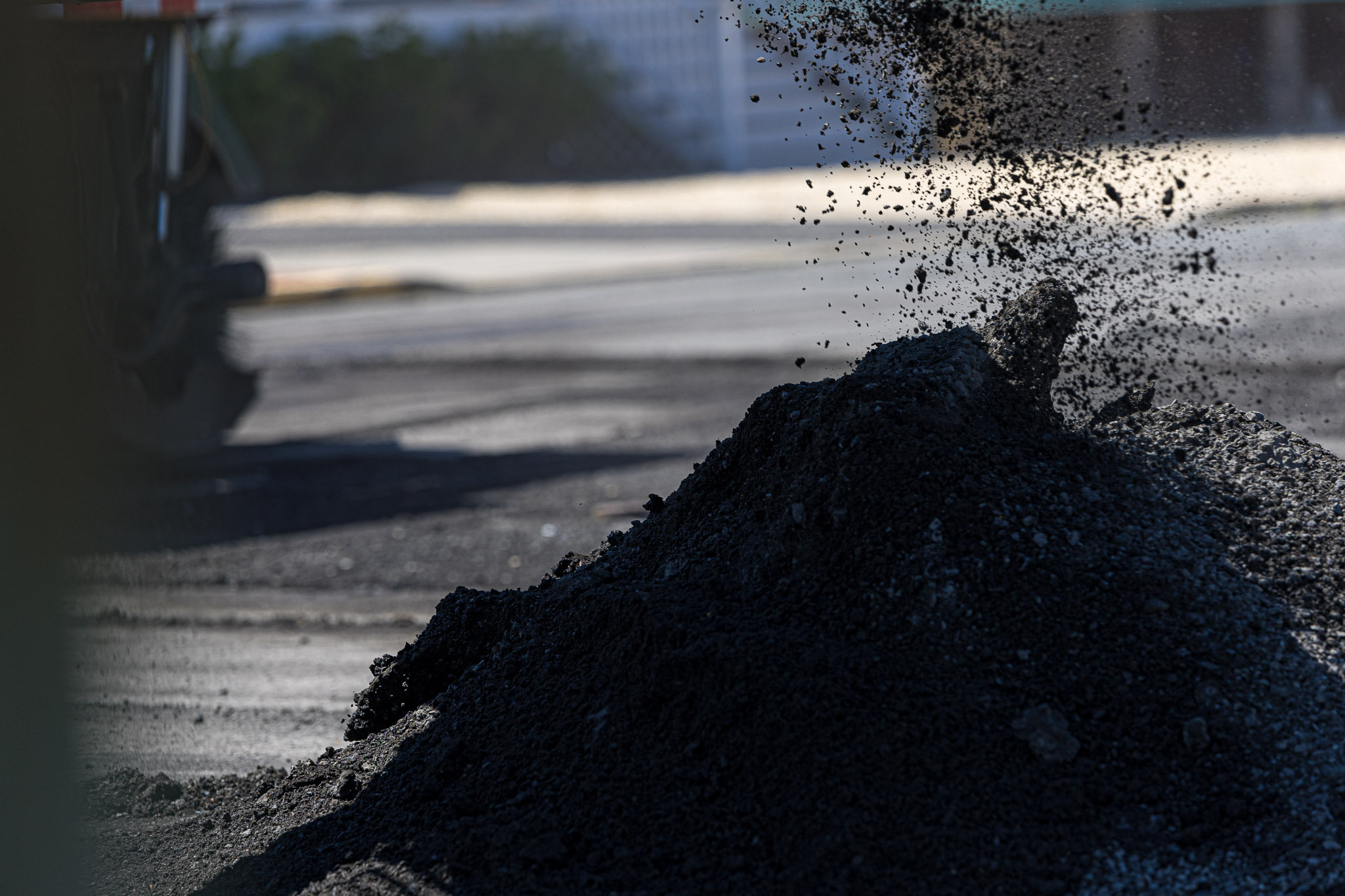 Soil-being-moved-into-pile-sitting-on-asphalt-parking-lot