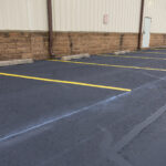 Freshly painted parking spots along wall of building