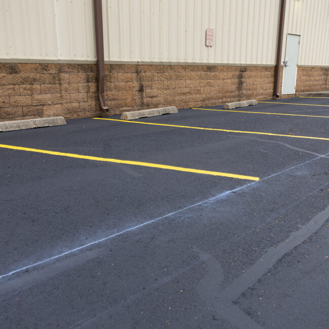 Freshly painted parking spots along wall of building
