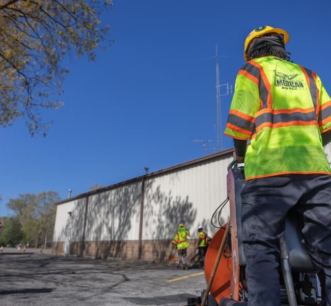 Work crew repairing commercial parking lot