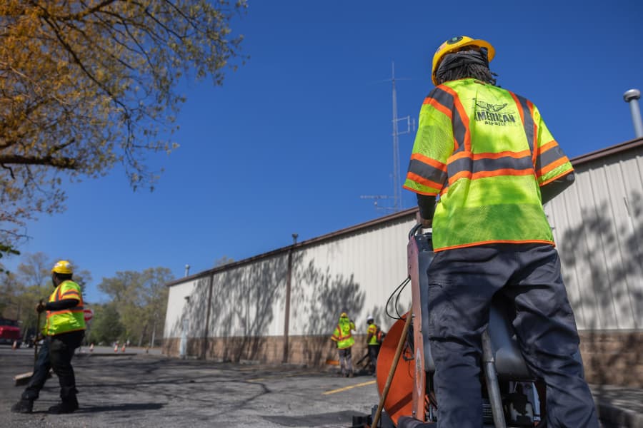 Work crew repairing commercial parking lot